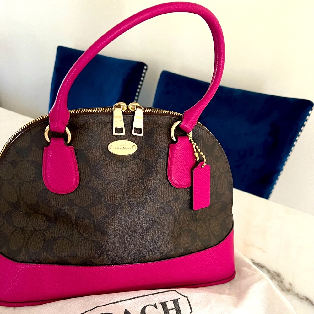 Coach signature cora domed handbag is made of coated
canvas and leather 🍉😉